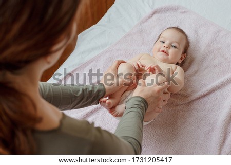 mother does back and a foot massage to a newborn baby. mother's care. healthy lifestyle.