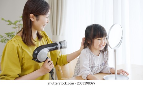 Mother Doing A Child's Hair Set