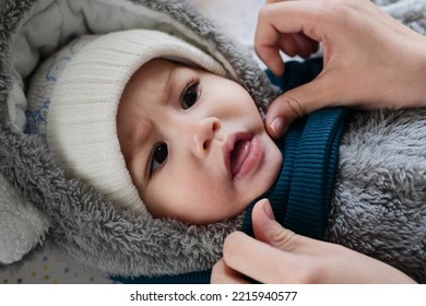 A Mother Dressing Her Little Baby Boy Boy At Home. Childhood Parenthood And Growing Up Family Concept Real People.