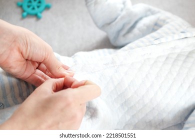 A Mother Dressing Her Little Baby Boy Boy At Home. Childhood Parenthood And Growing Up Family Concept Real People.