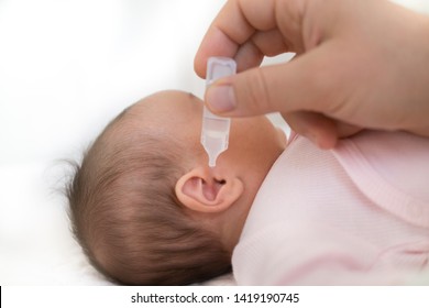 Mother Dribble Medication In Baby Ear. Ear Drops