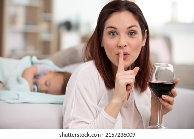 Mother Drink Wine While Baby Sleeping In Background