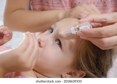 Mother Dripping Eye Medicine In The Child Girl Eyes