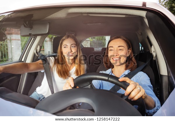 Mother driving\
with daughter on passenger\
seat