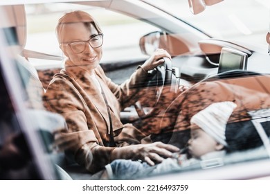 Mother Driving Family Car, Running Errands, While Her Baby Sleeps In Infant Car Seat By Her Site.