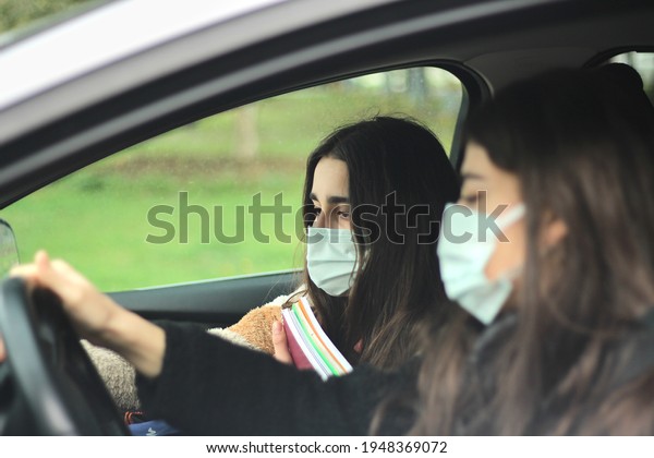 Mother\
driving her daughter to the school. Back to\
school