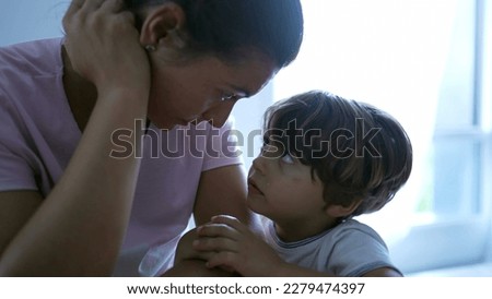 Mother educating child misbehavior. Small boy feeling guilty emotion leaning on mom. Parent talking to kid about behavior. Authentic parenting and childhood development concept