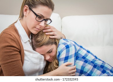 Mother Embracing And Soothes Depressed Teen Daughter By Problems