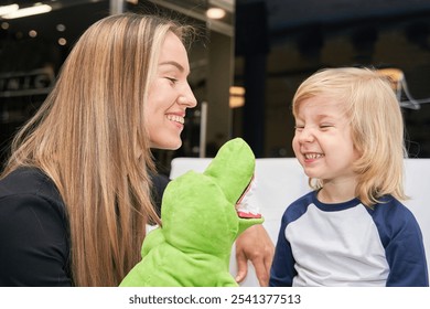 Mother engages her son in playful distraction at the dentist's waiting area, fostering a cheerful atmosphere amid dental care anticipation. - Powered by Shutterstock