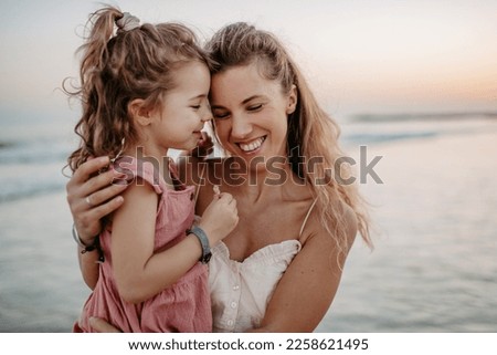 Mother enjoying together time with her daughter at sea.