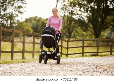 Mother Exercising By Running Whilst Pushing Baby Buggy