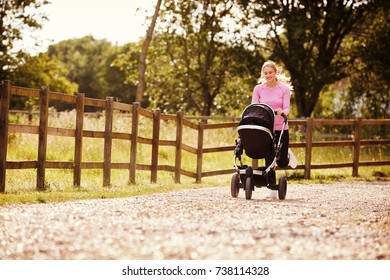 Mother Exercising By Running Whilst Pushing Baby Buggy