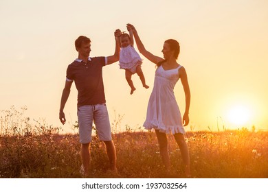 Mother, father and child daughter having fun outdoors.