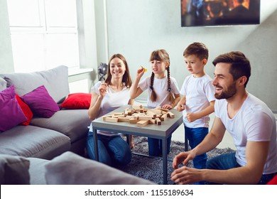 Mother, father and children play together.