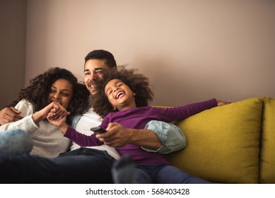 Mother, Father And Daughter Having Fun In The Living Room. Feeling Happy And Complete.