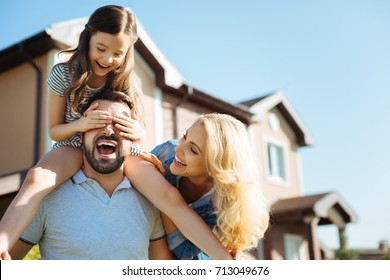 Mother and father having fun with their daughter outside