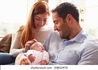 Mother And Father At Home With Newborn Baby