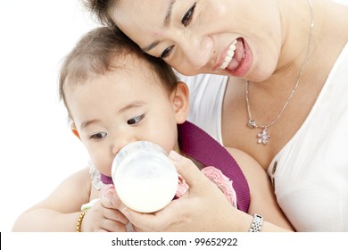 Mother feeding baby daughter
