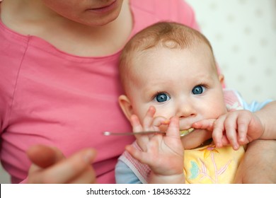 Mother Feeding Baby Food To Baby