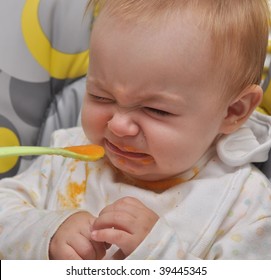 Mother Feeding Baby Food To Baby