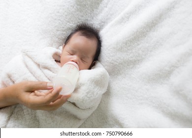  Mother Feeding Baby With Milk Bottle.