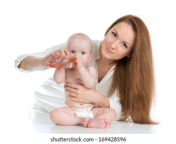 Mother Feeding Child Baby Girl Kid From Bottle With Fresh Drinking Water On A White Background