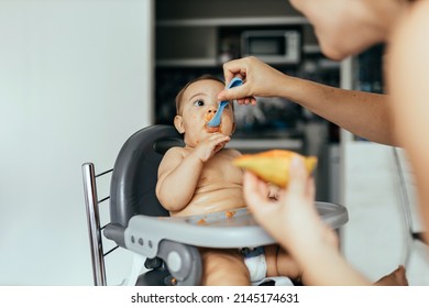 Mother Feeding Child. First Solid Food For Children. Baby Weaning