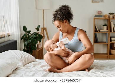 Mother feeding her baby from bottle - Powered by Shutterstock