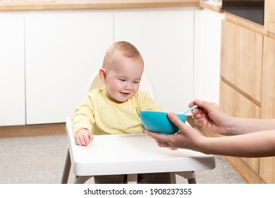 Mother Feeding Her Baby Son With Spoon - Mother Giving Healthy Food To Her Adorable Child At Home - Shutterstock ID 1908237355