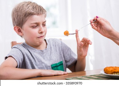 Mother Feeding A Picky Eater Son 