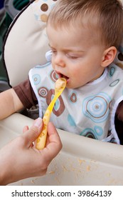 A Mother Feeds An Evidently Fussy Eater