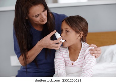 Mother, girl or bed with inhaler for asthma, chronic disease or breathing air at home. Mom, daughter or sick child with pump for medicine, medication or treatment for allergy, virus or blocked airway - Powered by Shutterstock