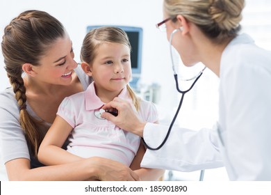 Mother with girl being examined by female pediatrician in clinic - Powered by Shutterstock