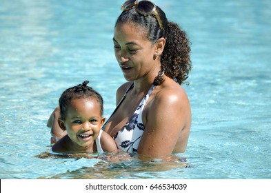 Mother Gives Daughter Swim Lesson In The Pool