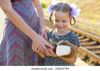 Mother Gives To Girl Her Favourite Toy