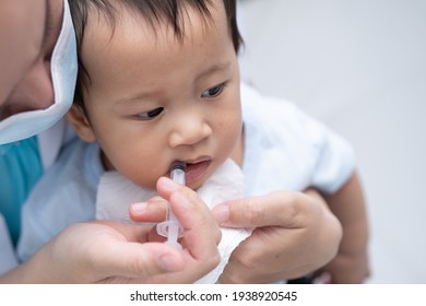 Mother gives medicine to baby at home. Boy catch an infection and take medicine by syringe, oral syringe.Selective focus. 