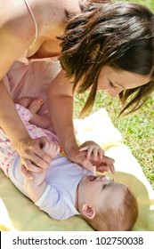 Mother Gives Sun Protection To Baby