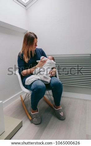 Image, Stock Photo Mother giving bottle to her newborn