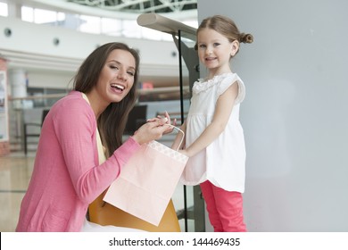 Mother Giving Daughter Paper Shopping Bag