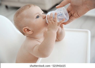 Mother Giving To Drink Water Baby From Bottle, Closeup