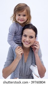 Mother Giving Her Daughter Piggyback Ride At Home