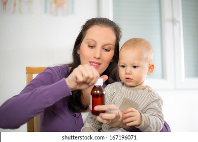 Mother Giving Medicine To Baby