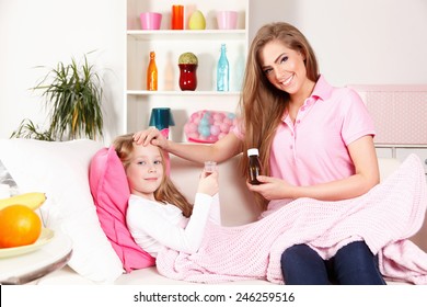 Mother Giving Medicine To Child