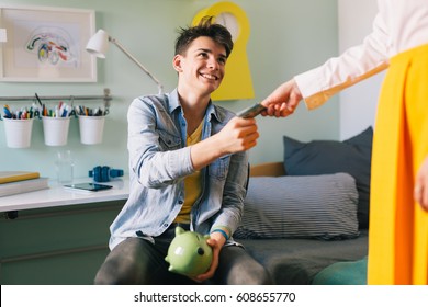 Mother Giving Pocket Money To Her Son.