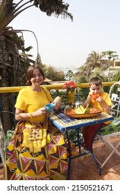 Mother Has Breakfast With Her Son On Ngor Island, Senegal, Africa. Table Layout, Table Setting For Breakfast. Woman With Child, Kid And Food. Tourist People Has Breakfast In Senegal, Africa. Banana