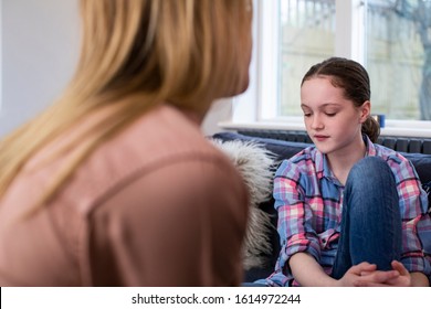 Mother Having Serious Conversation With Worried Young Daughter At Home