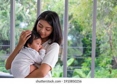 Mother Held Hug The Baby To Lull Him To Sleep. She Loves Her Child And Happy To Take Care. Baby Healthcare And Family Activity Concept.