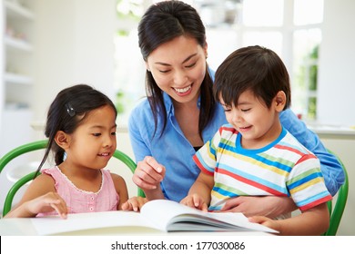 Mother Helping Children With Homework