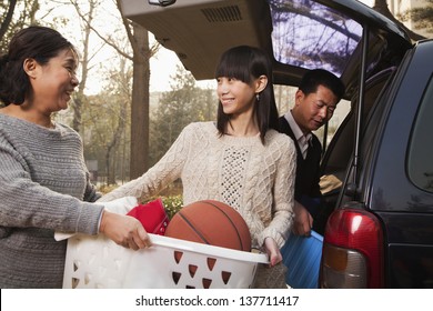 Mother Helping Daughter Unpack Car For College, Beijing