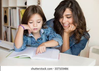 Mother Helping Her Little Child With Homework